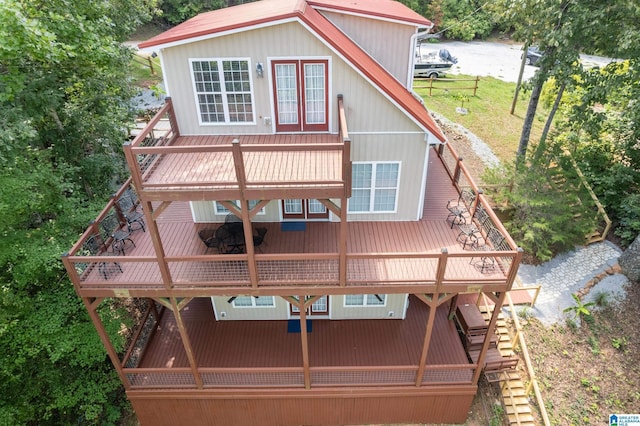 rear view of house with a balcony and a deck