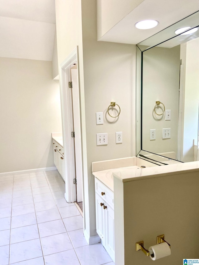 bathroom featuring tile patterned floors, baseboards, and vanity