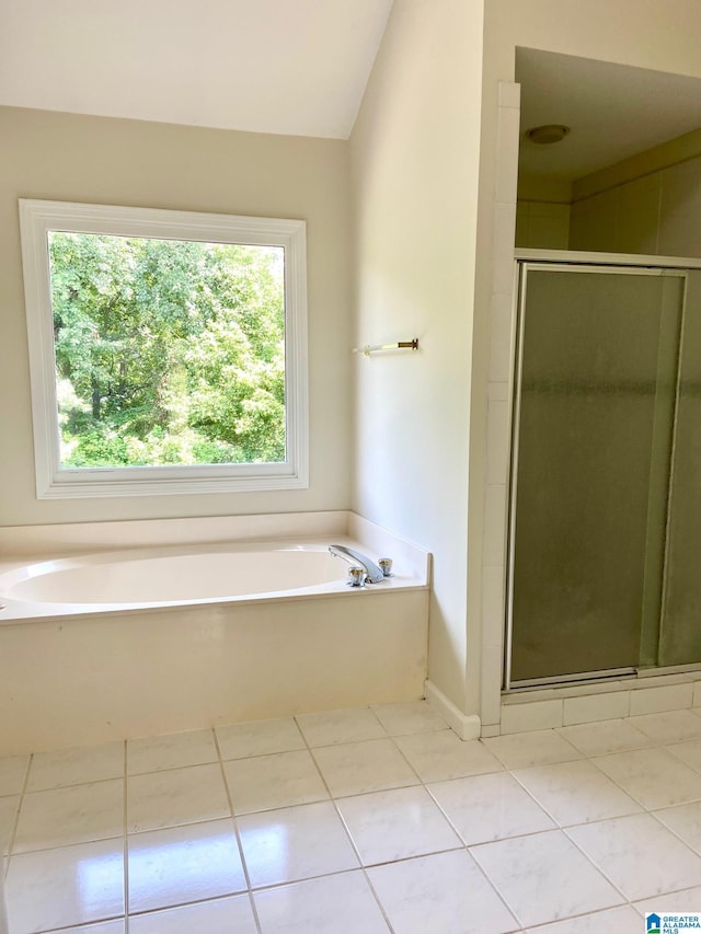 full bath featuring lofted ceiling, tile patterned flooring, a shower stall, and a bath