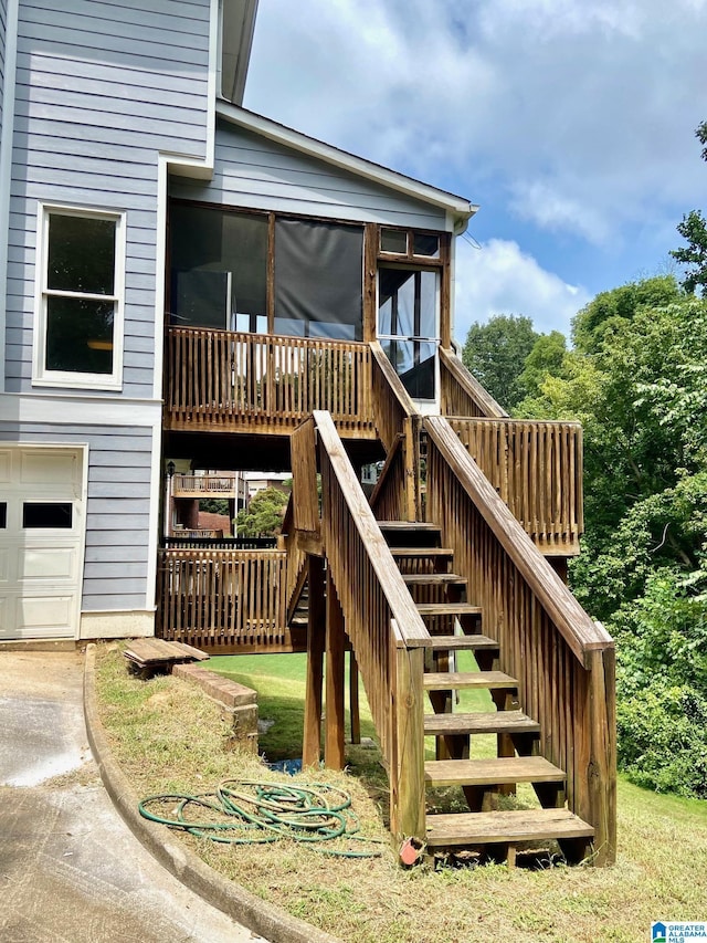 view of jungle gym with a sunroom and stairway