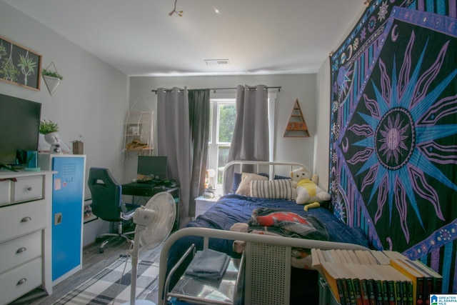 bedroom with hardwood / wood-style floors