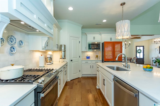 kitchen with appliances with stainless steel finishes, white cabinets, and tasteful backsplash