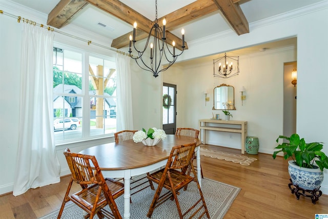 dining room featuring an inviting chandelier, ornamental molding, beamed ceiling, and light hardwood / wood-style floors