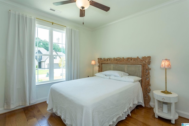 bedroom with ceiling fan, crown molding, and wood-type flooring