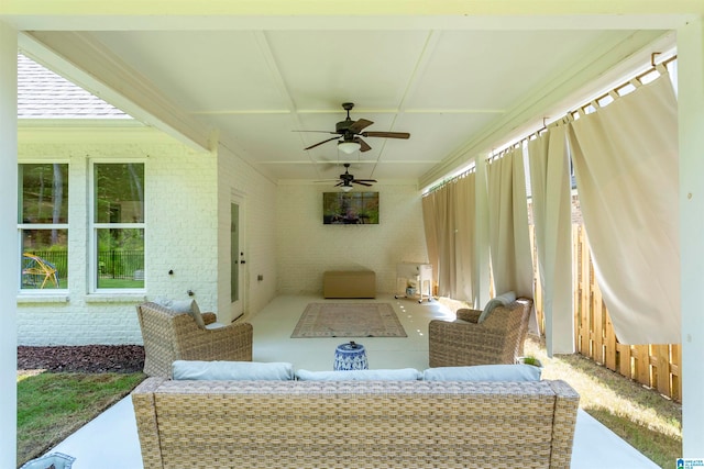 view of patio / terrace featuring ceiling fan and an outdoor living space with a fire pit