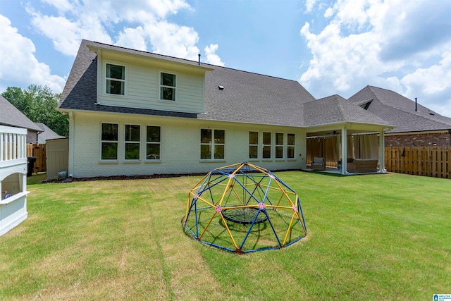 rear view of property featuring a yard