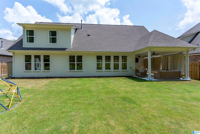 rear view of house featuring a lawn, a patio area, and ceiling fan