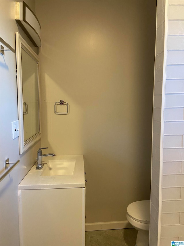 bathroom featuring vanity, toilet, and tile patterned floors