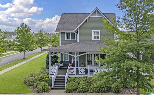 view of front of property featuring covered porch and a front yard