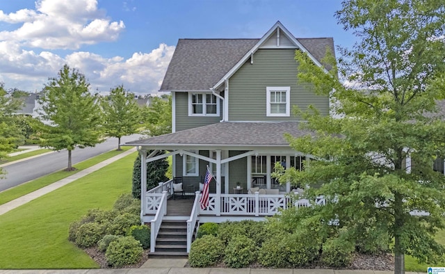 view of front of property featuring covered porch and a front yard