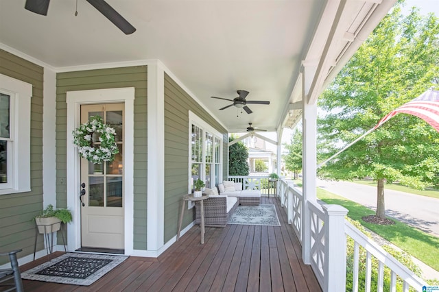 wooden deck featuring a porch and ceiling fan