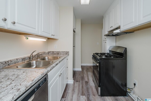 kitchen featuring dark wood-type flooring, white cabinets, and black gas range oven