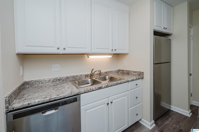 kitchen featuring stainless steel appliances, dark hardwood / wood-style flooring, sink, and white cabinets