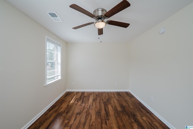 empty room featuring dark wood-type flooring and ceiling fan