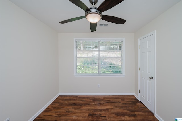 unfurnished room with ceiling fan and dark hardwood / wood-style flooring