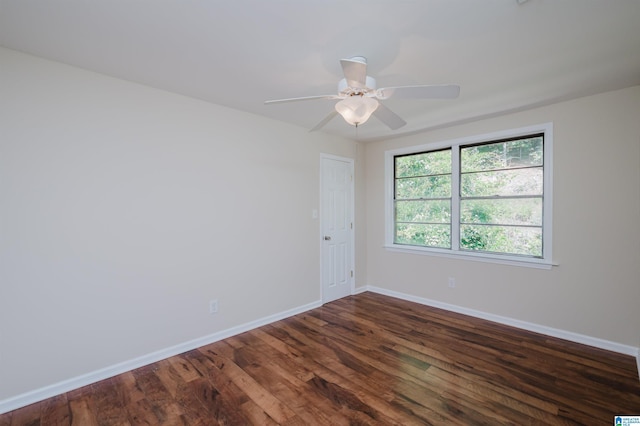 empty room with dark wood-type flooring and ceiling fan