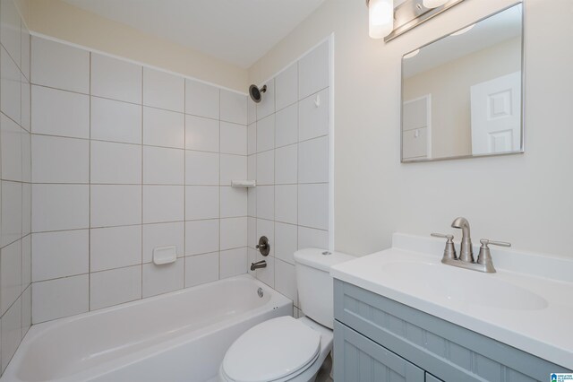 bathroom with tiled shower / bath combo and toilet