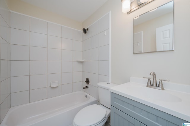 full bathroom with vanity, tiled shower / bath combo, and toilet