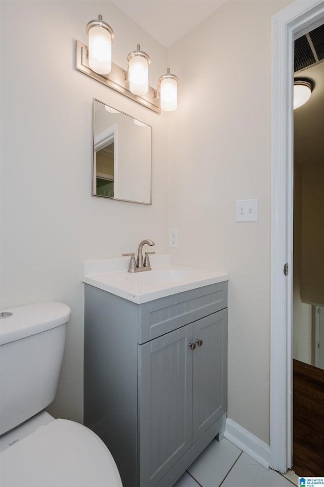 bathroom featuring vanity, toilet, and tile patterned flooring