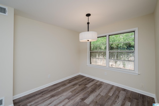 unfurnished room with dark hardwood / wood-style floors