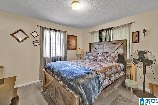 bedroom with a textured ceiling and carpet flooring