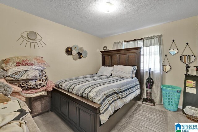 carpeted bedroom featuring a textured ceiling