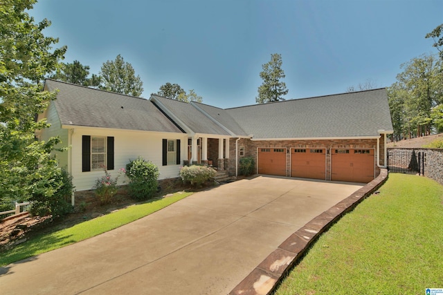 ranch-style house featuring a front yard and a garage