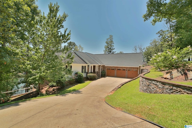 ranch-style home with a front lawn and a garage