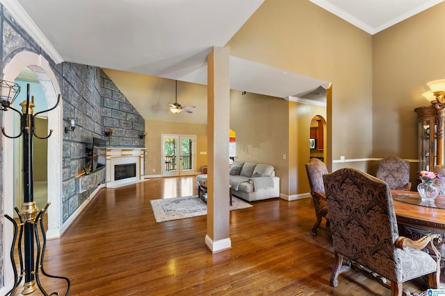 dining area featuring ornamental molding, hardwood / wood-style floors, a fireplace, and ceiling fan