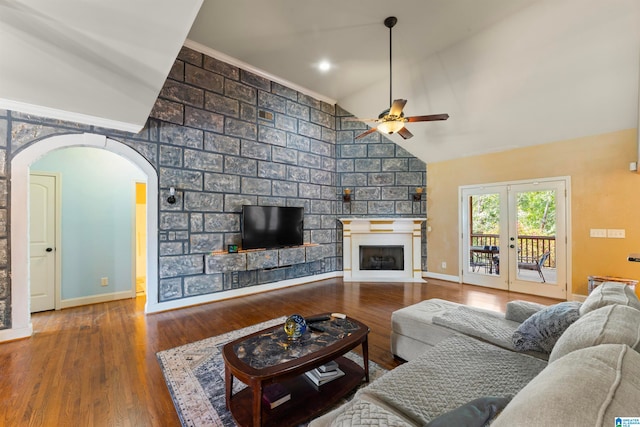 living room featuring a large fireplace, wood-type flooring, high vaulted ceiling, and ceiling fan