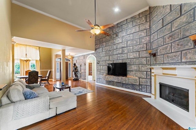 living room with ornamental molding, hardwood / wood-style flooring, and a large fireplace