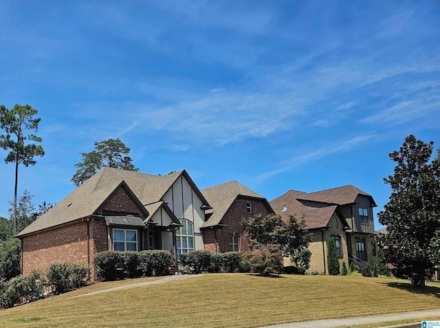 tudor home featuring a front yard