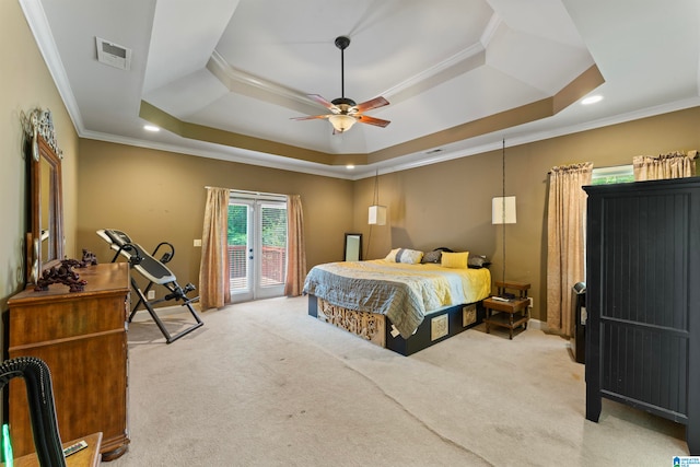 carpeted bedroom with crown molding, access to exterior, a tray ceiling, and ceiling fan