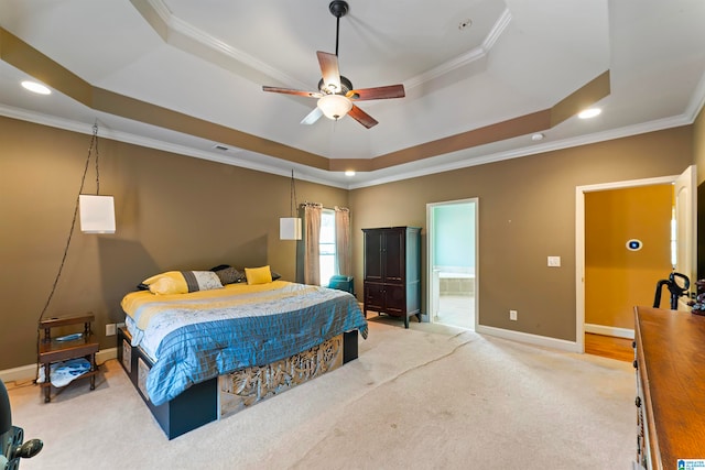 bedroom with ceiling fan, a raised ceiling, ornamental molding, and ensuite bathroom