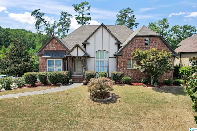 english style home featuring a front yard