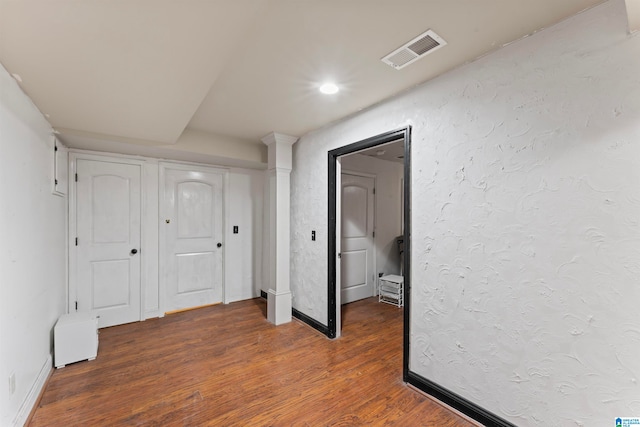 unfurnished bedroom with dark hardwood / wood-style flooring