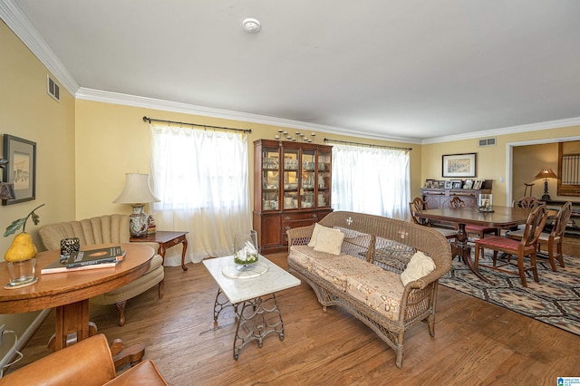 living room with hardwood / wood-style flooring and ornamental molding