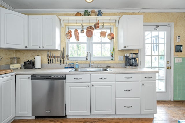 kitchen with plenty of natural light, sink, white cabinetry, and stainless steel dishwasher