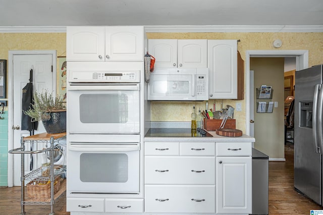 kitchen featuring ornamental molding, white cabinets, white appliances, and dark hardwood / wood-style flooring