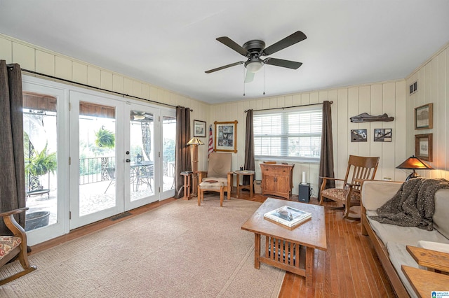 living room featuring light hardwood / wood-style flooring, ceiling fan, plenty of natural light, and french doors