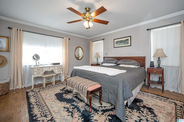 bedroom featuring ceiling fan, hardwood / wood-style floors, and crown molding