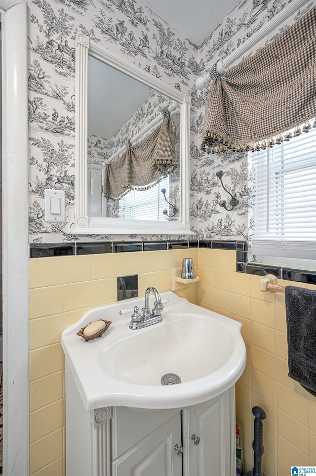 bathroom with vanity, tile walls, and plenty of natural light