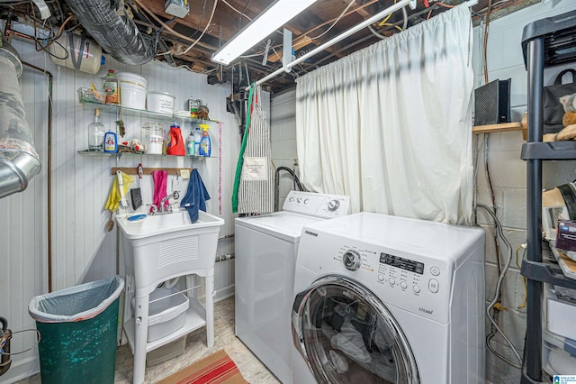 clothes washing area with separate washer and dryer