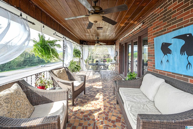 sunroom / solarium with ceiling fan and wooden ceiling