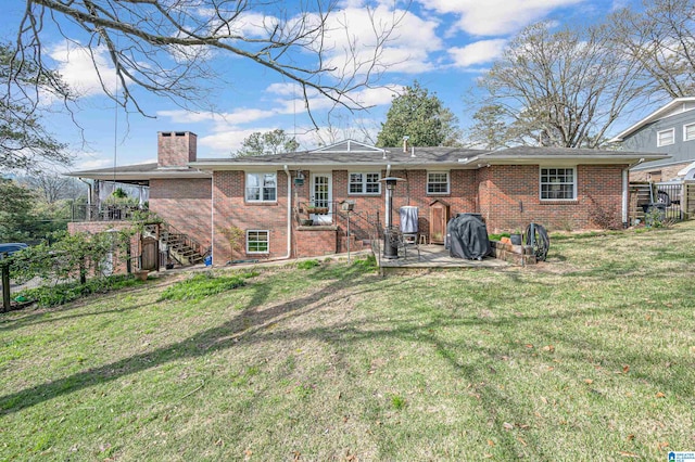 rear view of property with a lawn and a patio