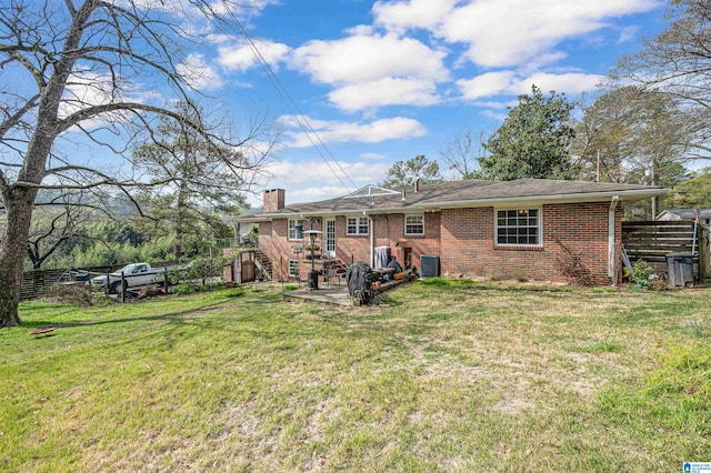 rear view of property featuring a yard