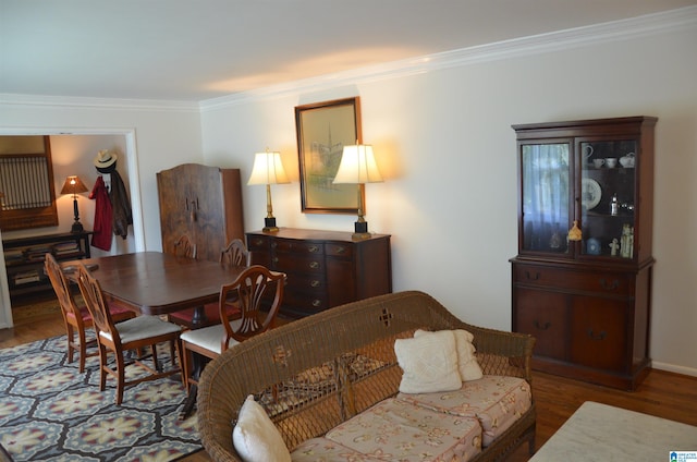 dining room featuring hardwood / wood-style flooring and ornamental molding