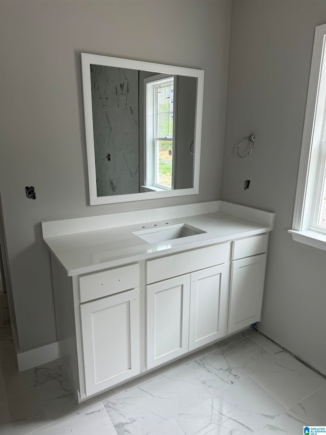 bathroom with tile patterned floors and vanity