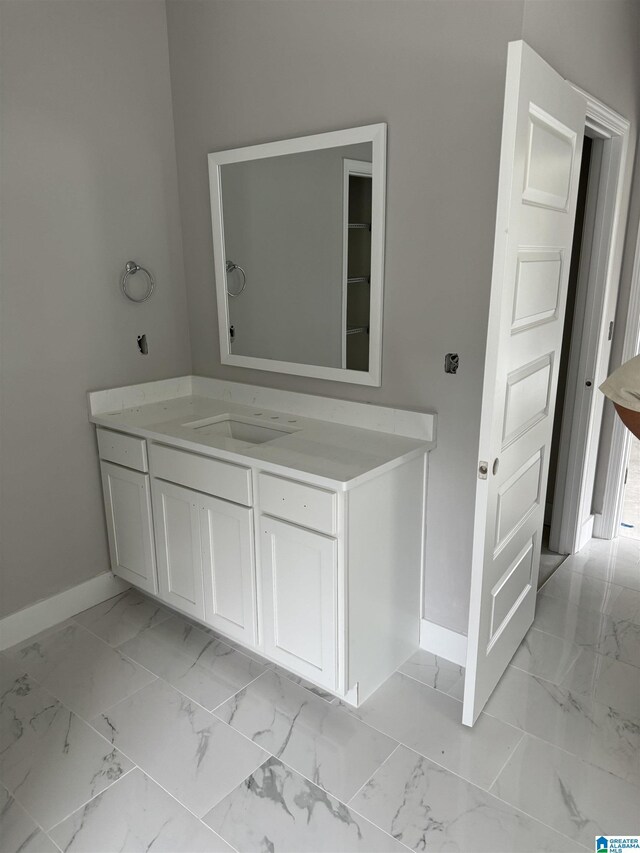 bathroom with tile patterned floors and vanity