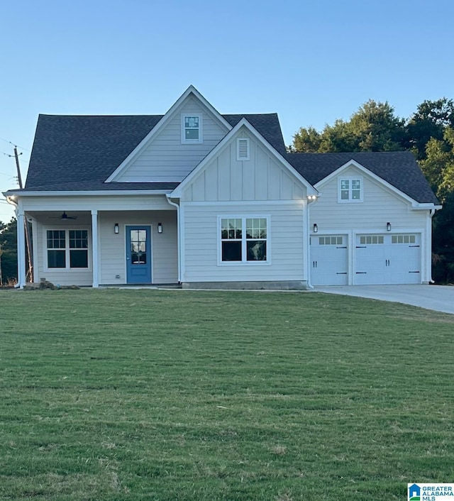 view of front facade with a porch, a front lawn, concrete driveway, a garage, and board and batten siding